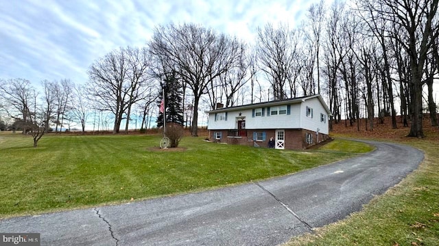 split foyer home with a front lawn