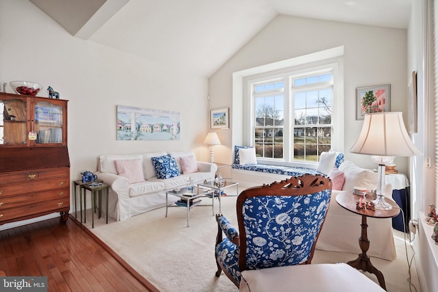 living room featuring hardwood / wood-style flooring and lofted ceiling