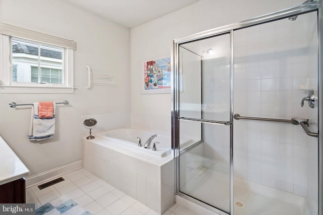 bathroom with tile patterned floors and shower with separate bathtub