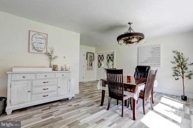 dining room featuring a chandelier and light hardwood / wood-style floors