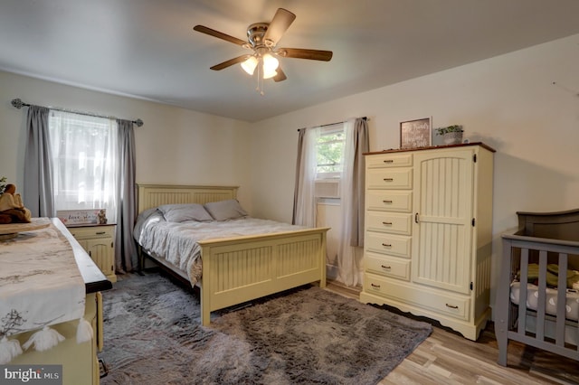 bedroom with light hardwood / wood-style floors and ceiling fan