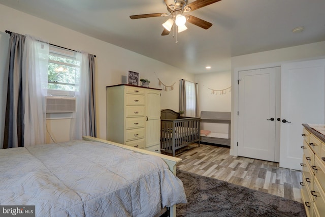 bedroom with ceiling fan and light hardwood / wood-style flooring