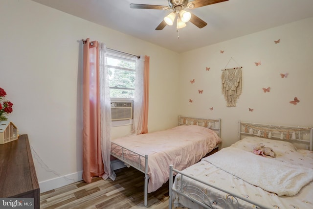 bedroom with ceiling fan, light hardwood / wood-style floors, and cooling unit