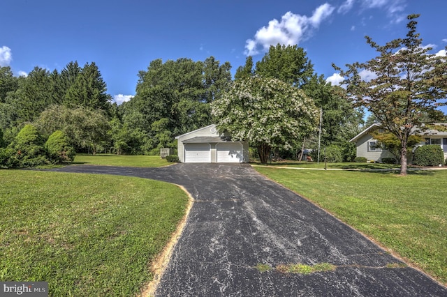 view of front of house featuring a front yard and a garage