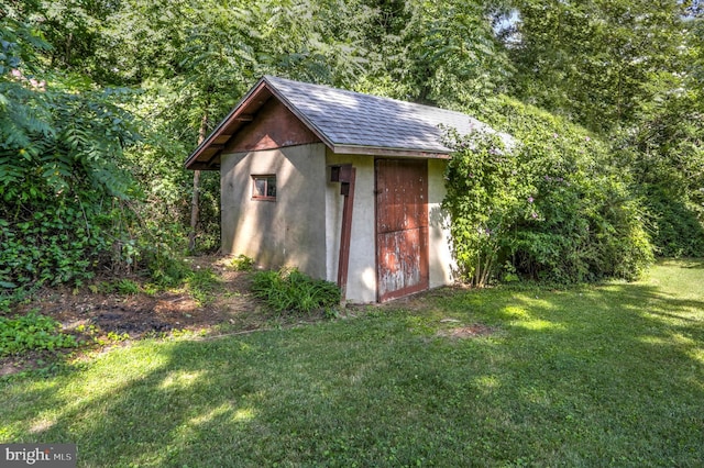 view of outbuilding with a lawn