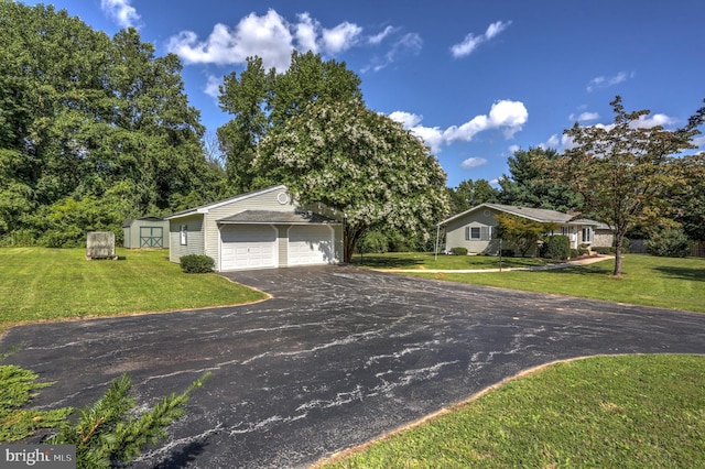 ranch-style house featuring a storage shed and a front yard