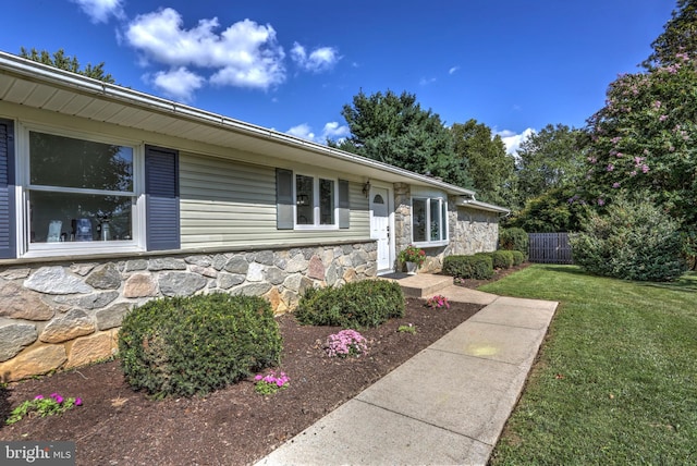 ranch-style home with a front lawn