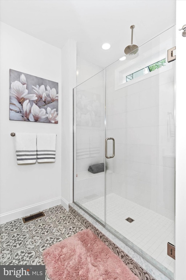 bathroom with tile patterned flooring and an enclosed shower