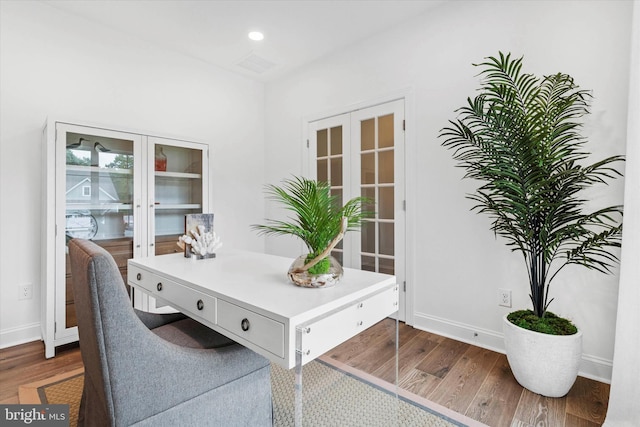 home office with french doors and dark hardwood / wood-style flooring