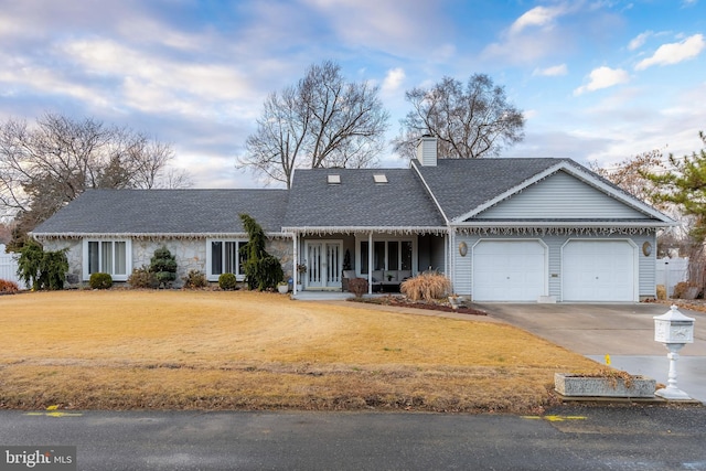 ranch-style home with a garage and covered porch