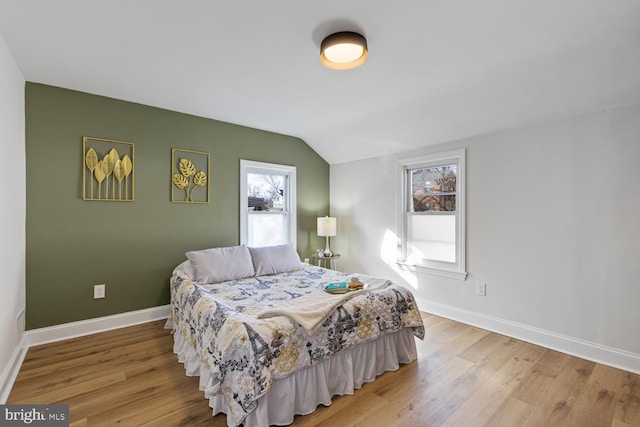 bedroom featuring vaulted ceiling and light hardwood / wood-style flooring