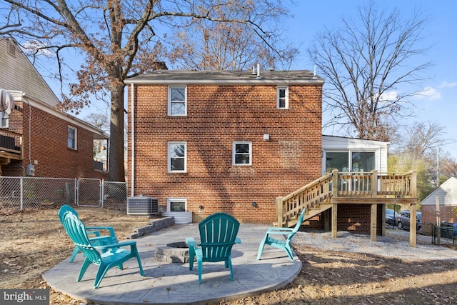 back of property featuring cooling unit, an outdoor fire pit, a patio area, and a wooden deck