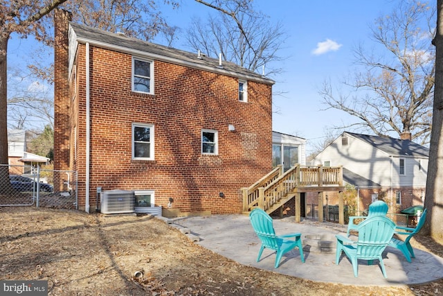 rear view of house featuring cooling unit, a deck, and a patio