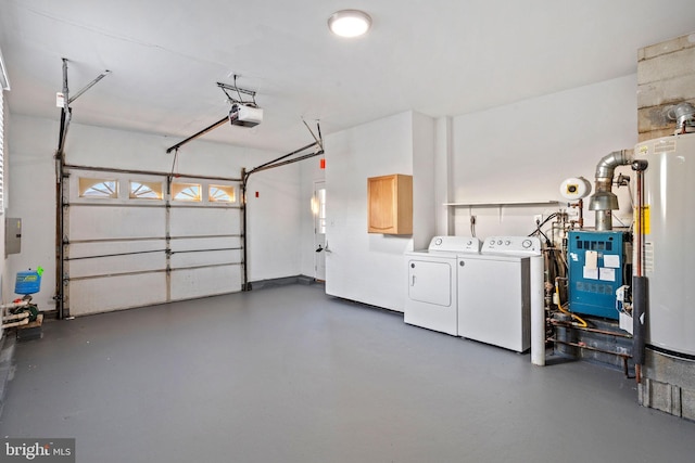 garage with electric panel, washer and clothes dryer, a garage door opener, and gas water heater