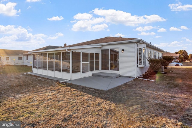 rear view of house with a sunroom and a patio area