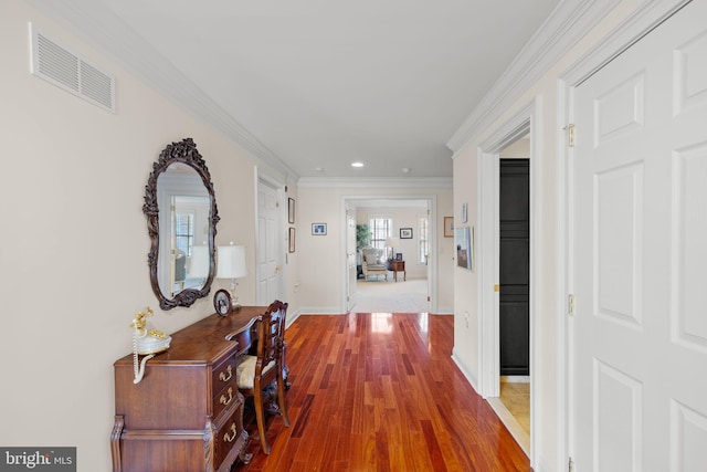 hallway featuring hardwood / wood-style floors and crown molding