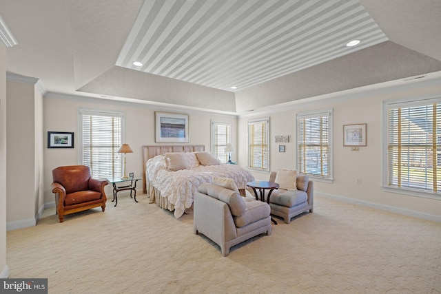 carpeted bedroom featuring a tray ceiling and crown molding