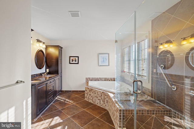 bathroom with tile patterned flooring, vanity, and shower with separate bathtub