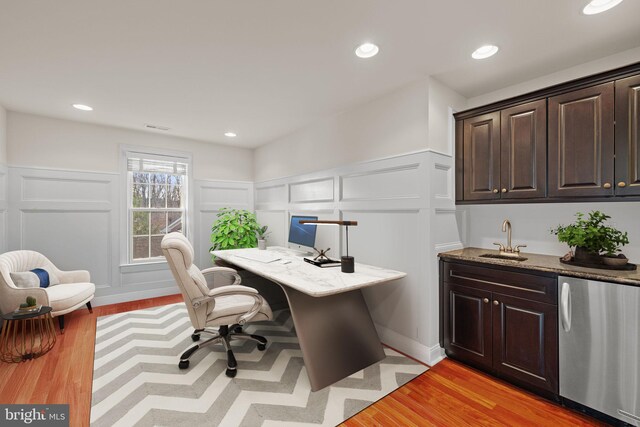 office area featuring sink and light hardwood / wood-style flooring