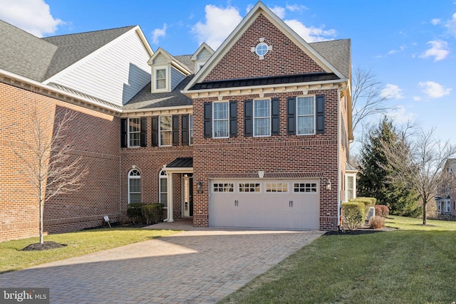 view of front of property with a garage and a front lawn