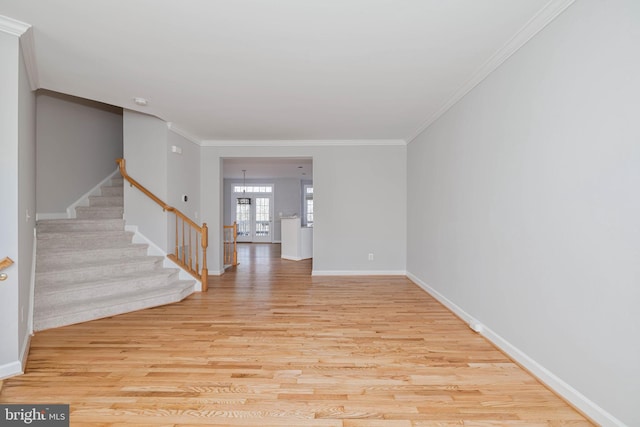 interior space with ornamental molding and light wood-type flooring