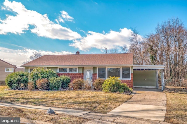 view of front of property with a carport and a front yard