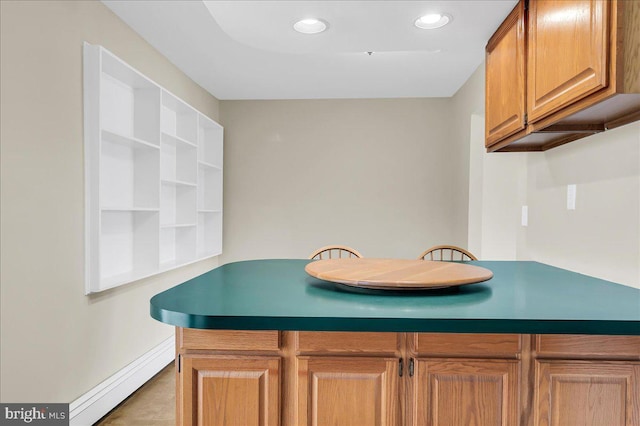 kitchen with kitchen peninsula and baseboard heating