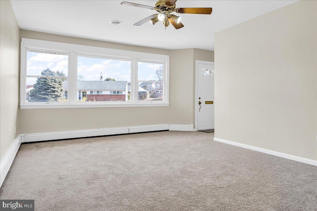 empty room with a baseboard radiator, carpet floors, and ceiling fan