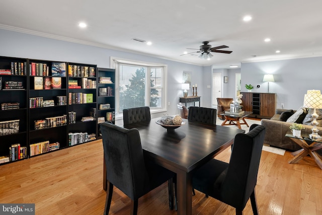 dining area featuring ceiling fan, light hardwood / wood-style floors, and crown molding