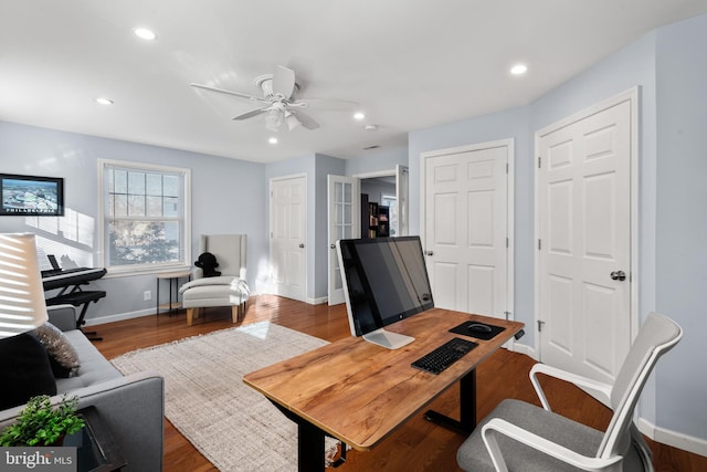 home office with ceiling fan and dark hardwood / wood-style flooring