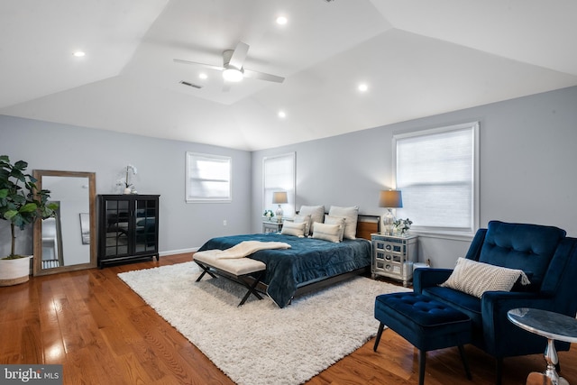 bedroom featuring ceiling fan, lofted ceiling, and hardwood / wood-style flooring