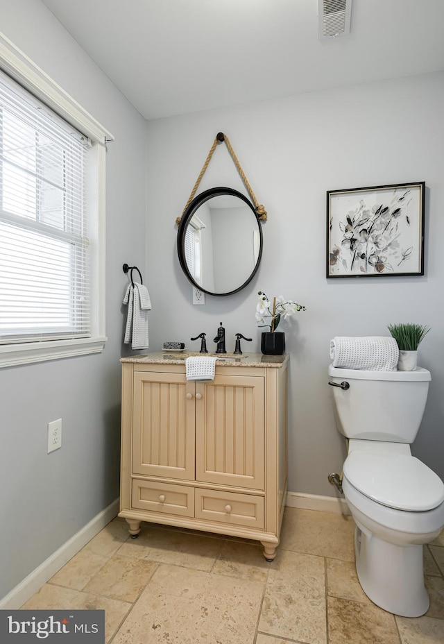 bathroom featuring vanity and toilet