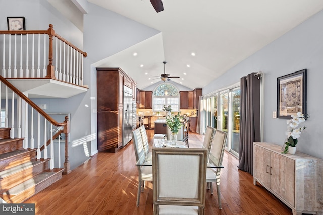 dining room featuring ceiling fan, hardwood / wood-style floors, and lofted ceiling