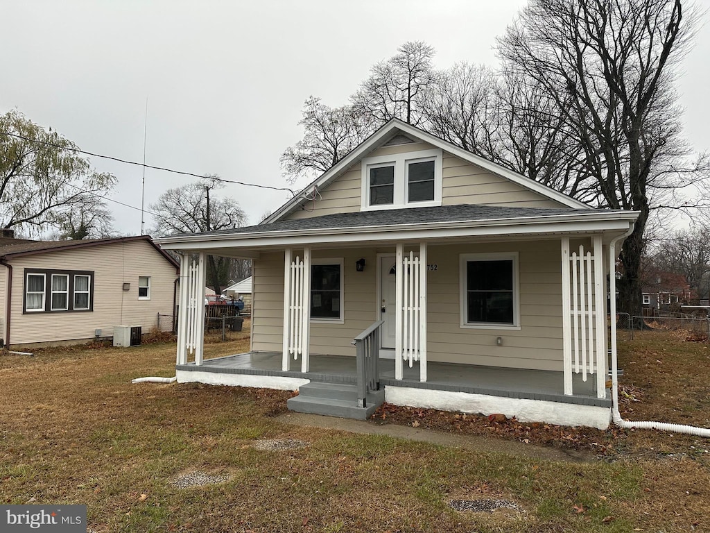 bungalow-style home with a porch and a front lawn