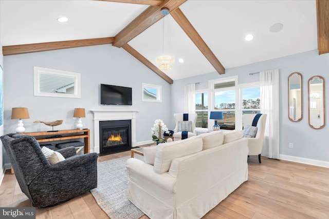 living room featuring lofted ceiling with beams and light hardwood / wood-style floors