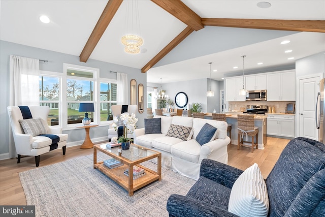 living room with beamed ceiling, high vaulted ceiling, light hardwood / wood-style floors, and an inviting chandelier