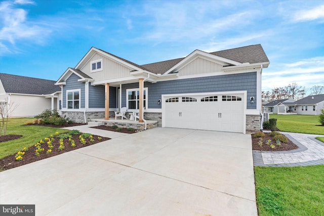 craftsman house with a porch, a garage, and a front yard