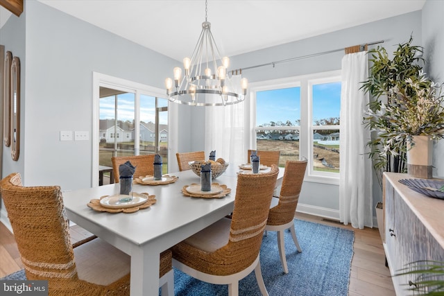 dining room featuring light hardwood / wood-style flooring and a chandelier