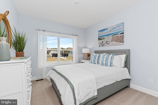 bedroom featuring light colored carpet