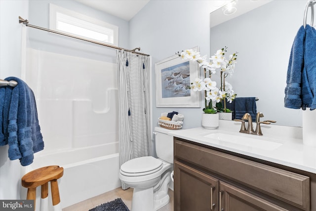 full bathroom with tile patterned flooring, shower / bath combo with shower curtain, vanity, and toilet