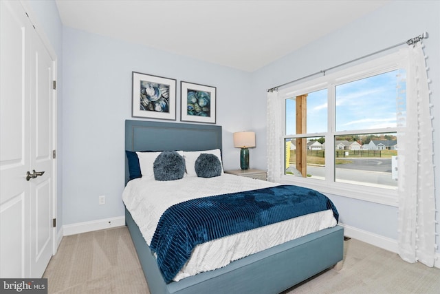 carpeted bedroom featuring a closet