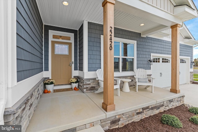 view of exterior entry featuring covered porch