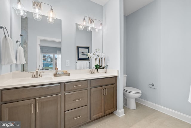 bathroom with tile patterned floors, vanity, and toilet