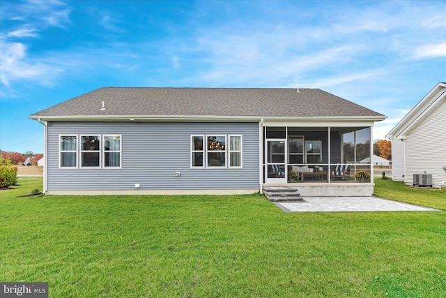 rear view of house with a sunroom, central AC unit, a patio area, and a yard