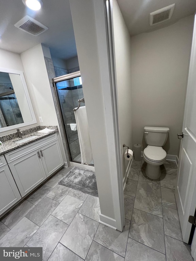 bathroom featuring vanity, toilet, and walk in shower