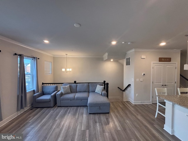 living room featuring ornamental molding, an inviting chandelier, and dark wood-type flooring