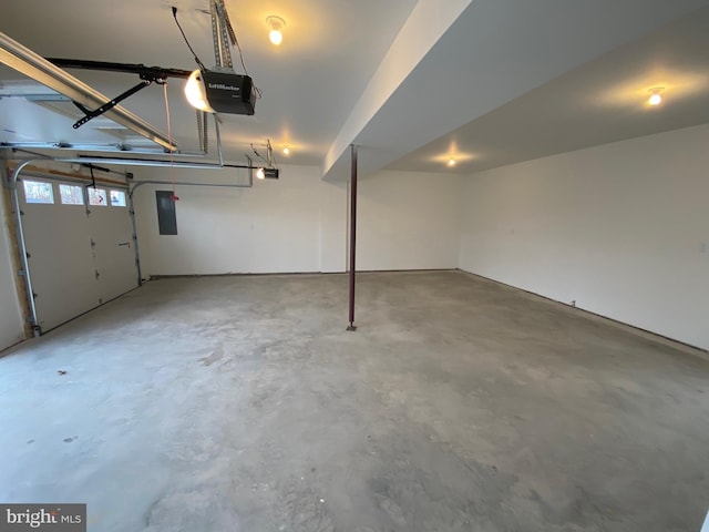 garage featuring electric panel and a garage door opener