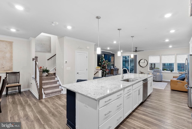 kitchen featuring ceiling fan, sink, an island with sink, white cabinets, and appliances with stainless steel finishes