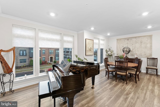 miscellaneous room with ornamental molding and light hardwood / wood-style flooring