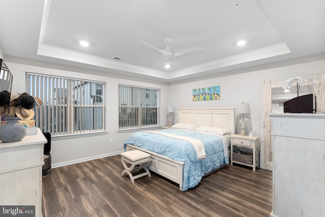 bedroom featuring ceiling fan, dark hardwood / wood-style floors, ornamental molding, and a tray ceiling